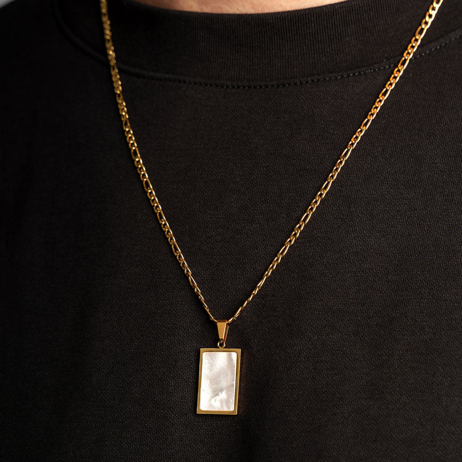 Our Premium Rectangle Pendant paired with our Signature Figaro Chain is the perfect touch of Gold & White.